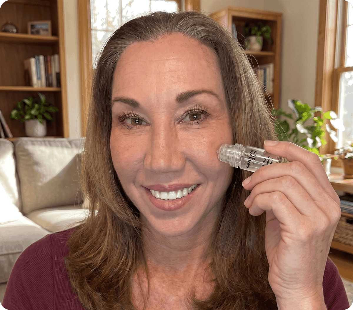 Woman using the RenewaLift skincare device